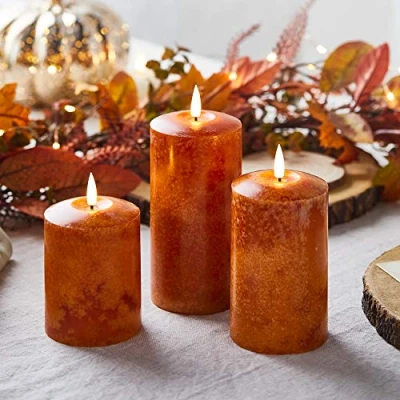 Imagen de Lights4fun Conjunto de 3 Velas Pilar TruGlow® Color Naranja con Efecto Moteado a Pilas para Uso en Interiores