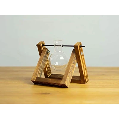 Imagen de Elegante jarrón decorativo con forma de pistón redondo, marco madera flameada un émbolo cristal transparente soplado artesanalmente.