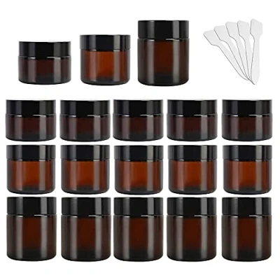Imagen de Yishik Paquete de 15 frascos vidrio ámbar, 2 onzas, recipientes redondos vacíos para cosméticos, viaje recargables con tapas negras y revestimientos interiores blancos
